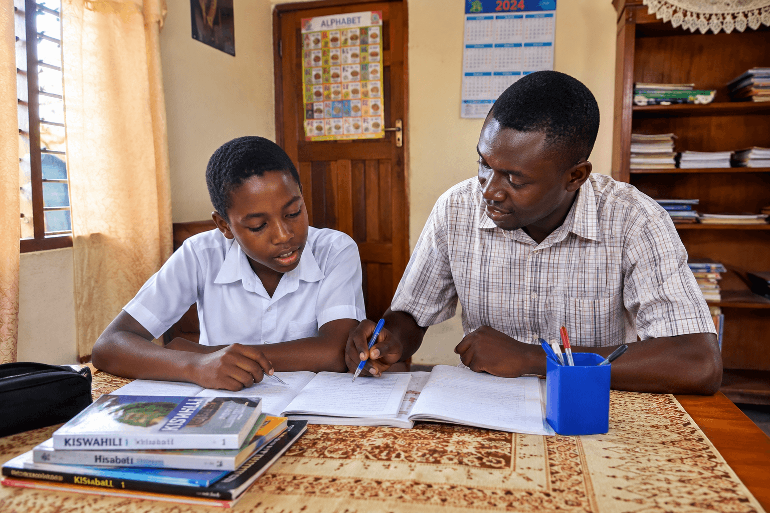 A teacher helping a student with homework at home
